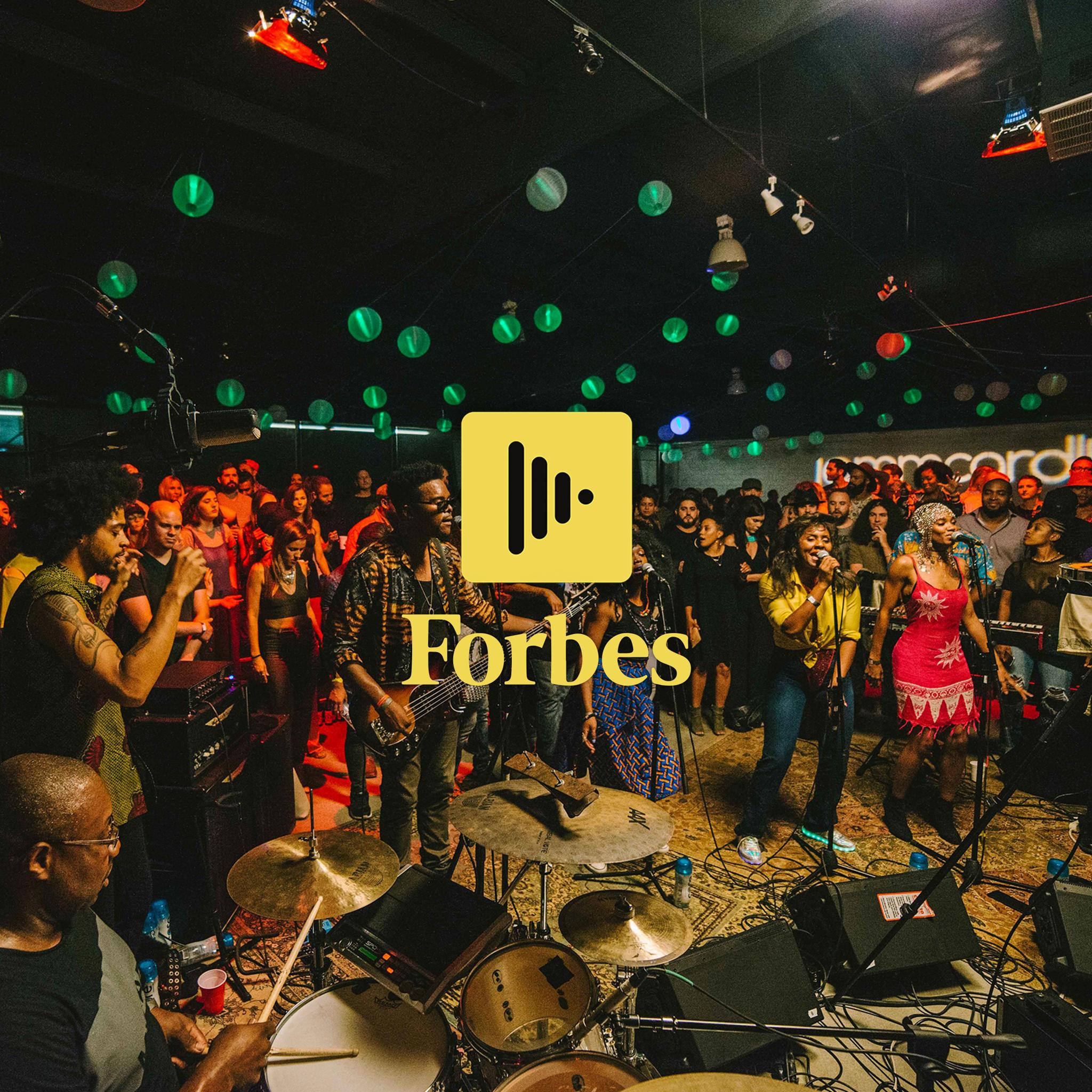 Live band in a crowded venue with yellow audio icon and Forbes text overlay