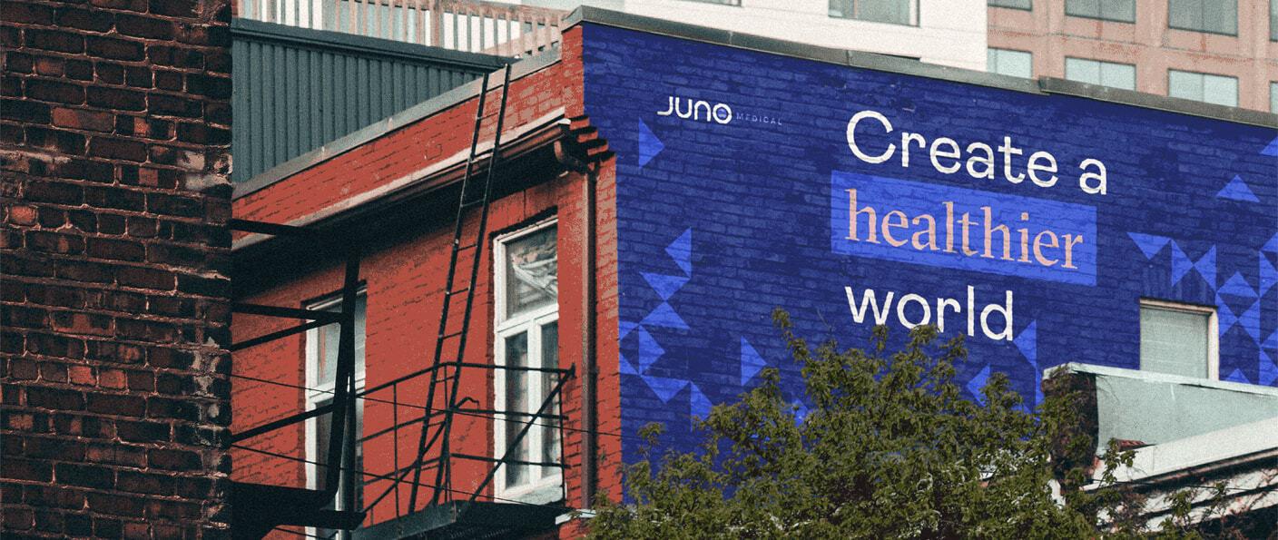 Blue Juno Medical mural reading Create a healthier world on a building