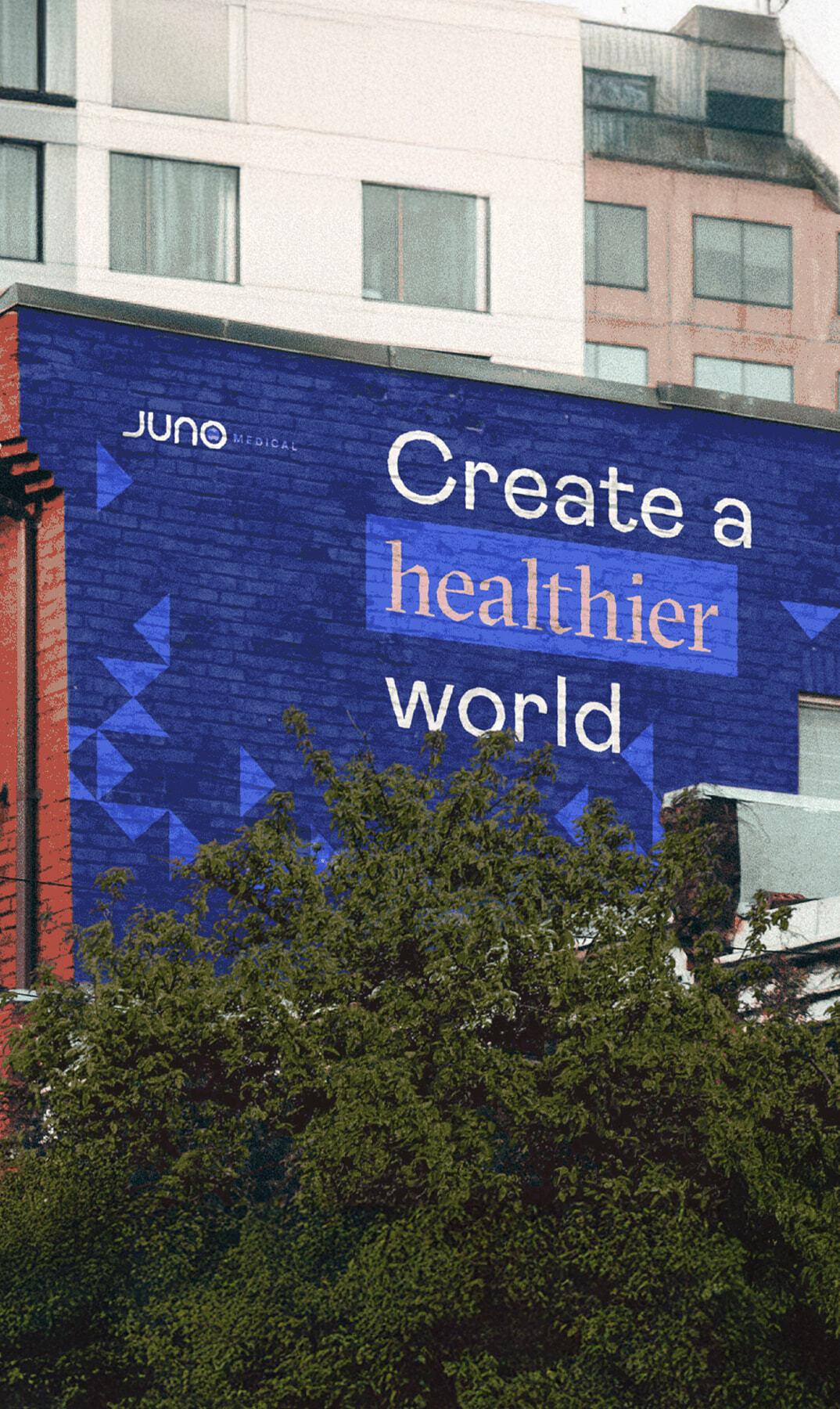 Juno Medical mural reading Create a healthier world on a brick wall