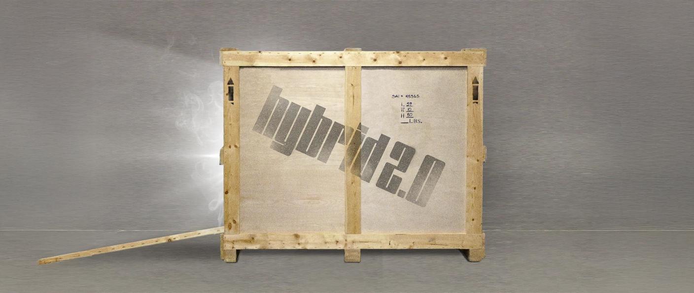 Wide view of a wooden shipping crate on a gray floor with a loose plank at left