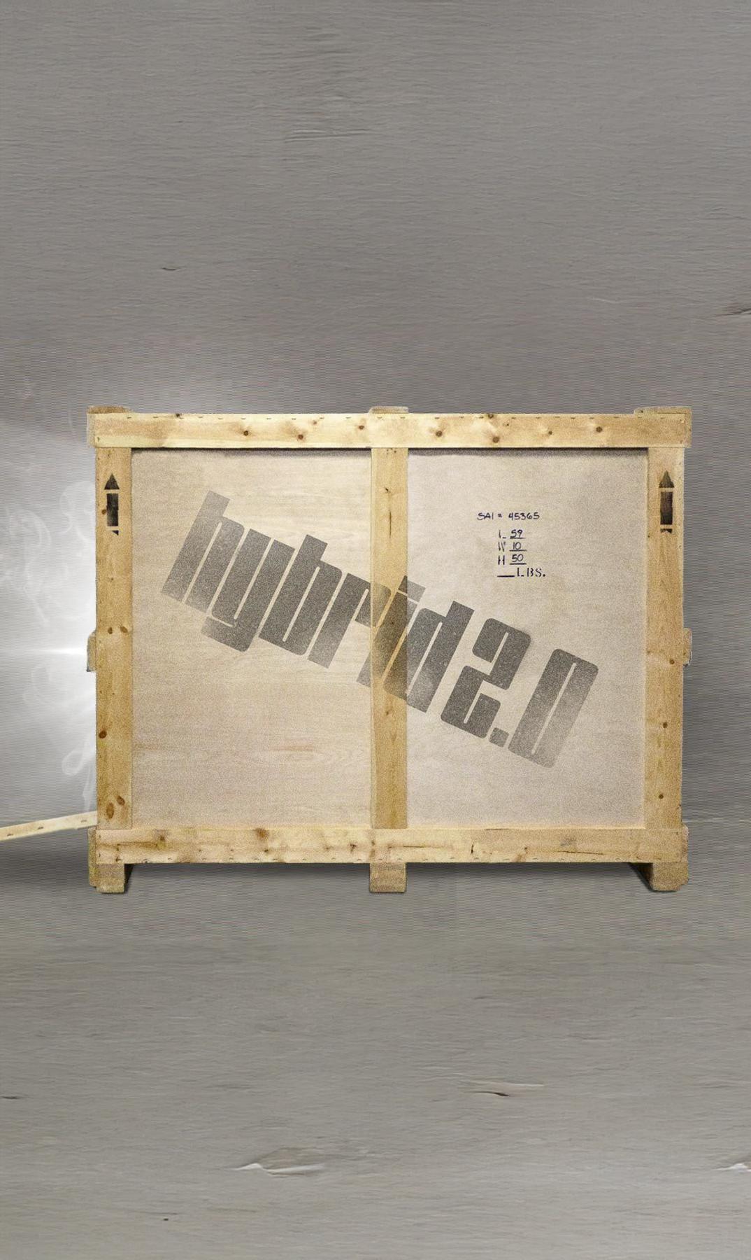 Wooden shipping crate on a gray floor with stenciled branding