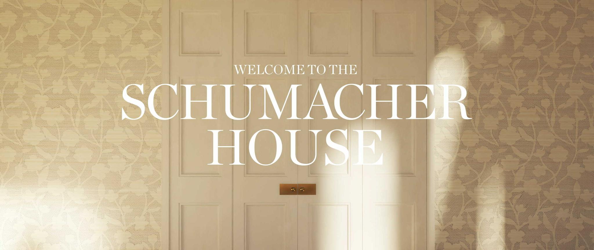 Wide view of paneled doors with text reading Welcome to the Schumacher House