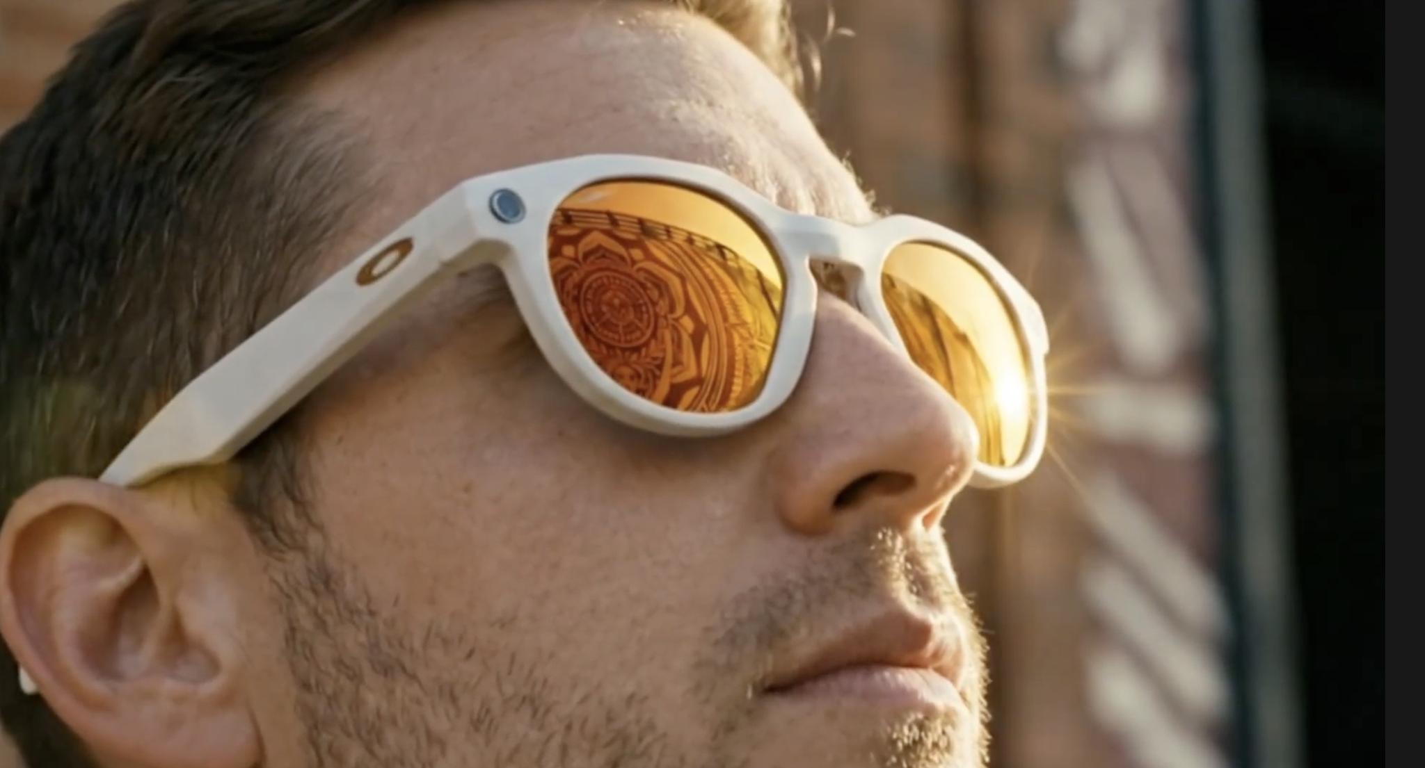 Close-up of a person wearing white-framed smart glasses with amber lenses