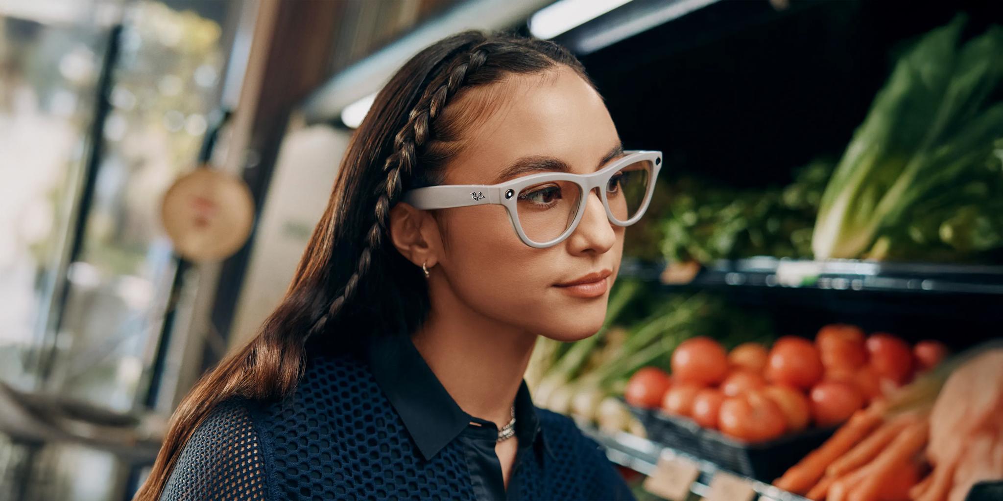 Young woman wearing smart glasses browses produce in a grocery store