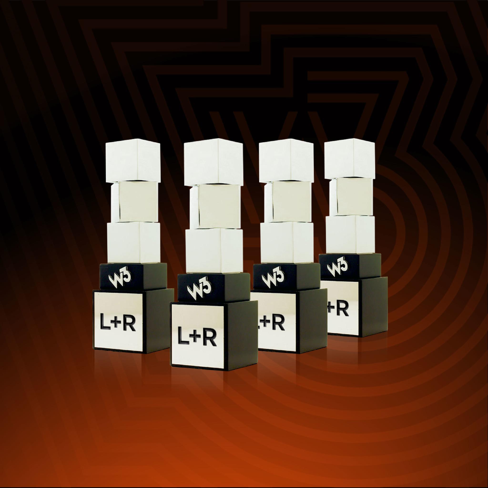 Four w3 Awards trophies with L+R engraved on their bases