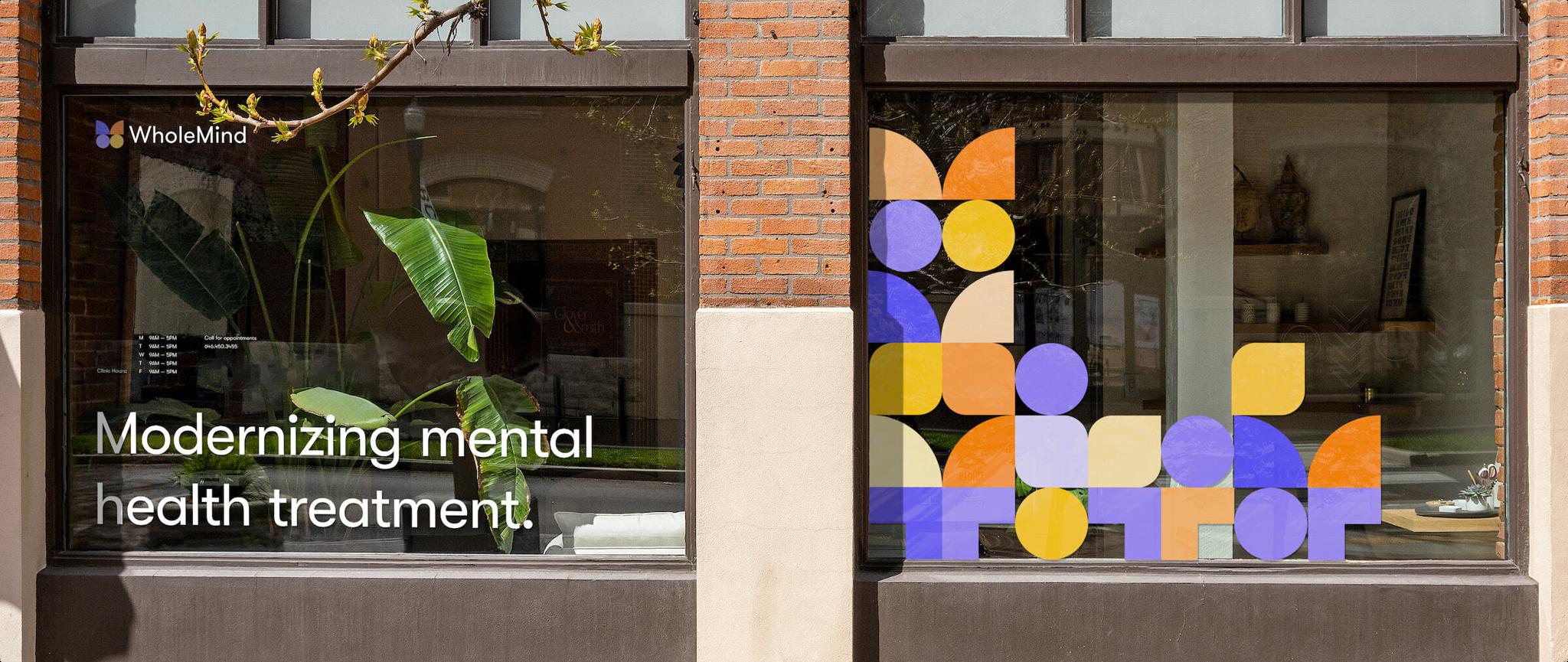Storefront windows with WholeMind logo, mental health treatment text, and colorful geometric patterns