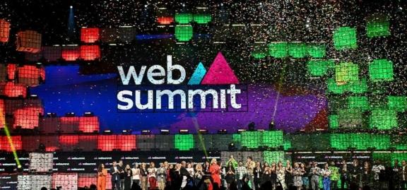 Web Summit stage with confetti and colorful cube lights
