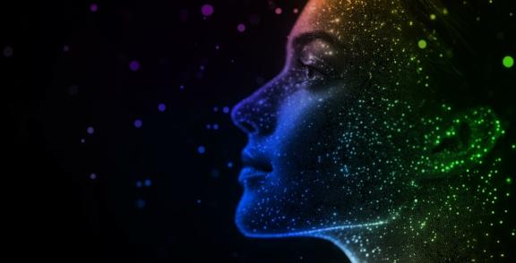 Profile of a face formed with glowing digital particles