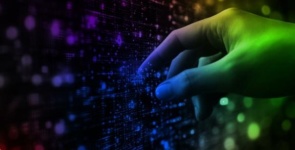 Hand touching a glowing digital data wall
