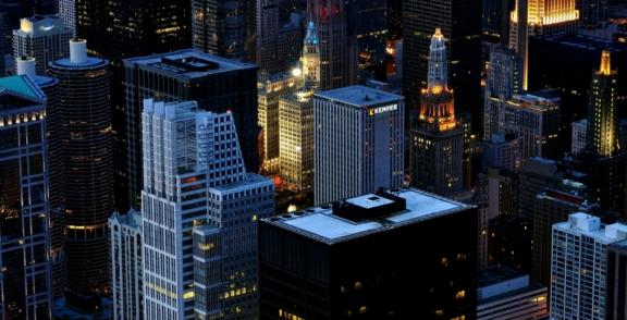 Business Desktop min Downtown city skyline at dusk with illuminated high-rise buildings