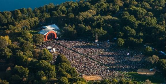 Non Profit 2 min Aerial view of a large outdoor concert crowd in a wooded park
