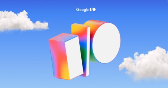 Google I/O graphic with colorful 3D shapes in a blue sky with clouds