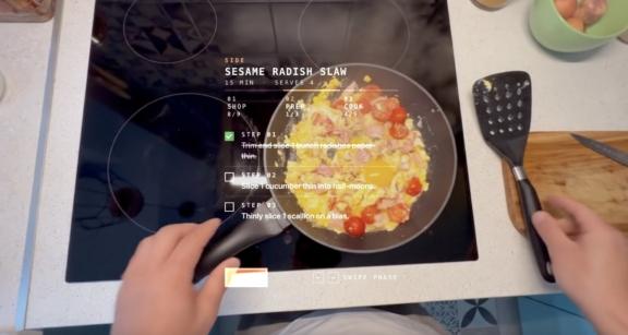 A cooking interface overlays recipe steps on a pan of vegetables on a stovetop.
