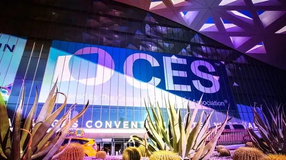 CES sign projected on a convention center exterior at night