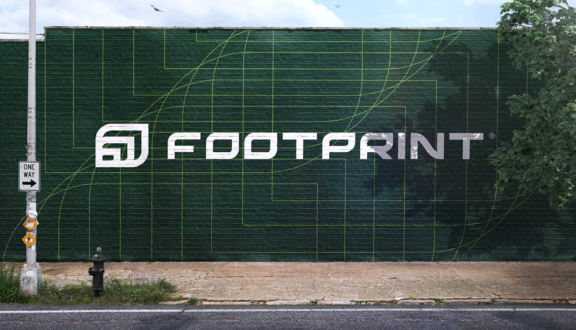 Large Footprint logo mural painted on a dark green brick wall