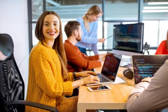 People working at laptops in a modern office
