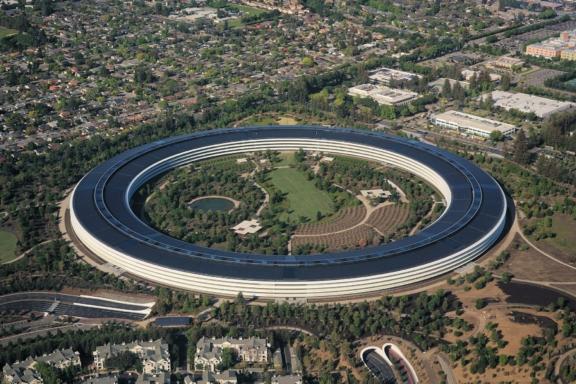 Aerial view of Apple Park circular campus surrounded by trees