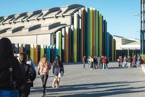 La Nave Exterior People walking toward a modern building with tall colorful vertical panels