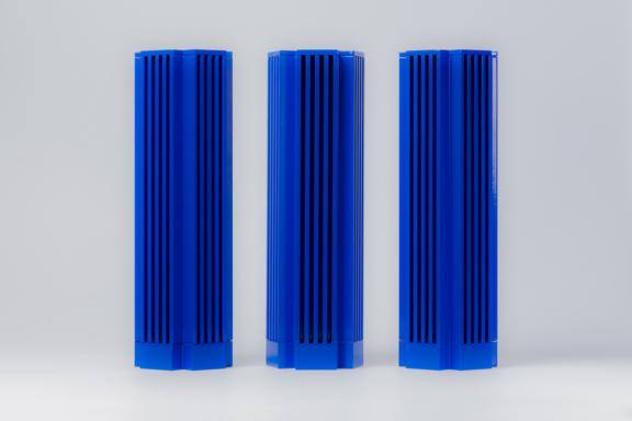 Three tall blue ribbed rectangular objects on a light gray background