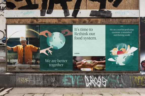 Rethink food system campaign posters on a boarded storefront