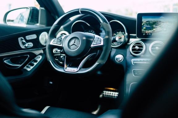 Mercedes-Benz car interior with steering wheel and dashboard display