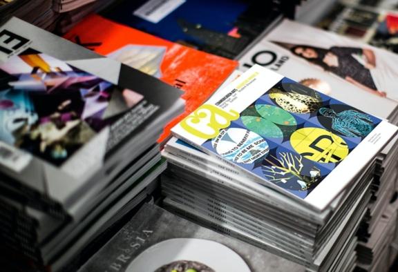 Stacks of design magazines on a table