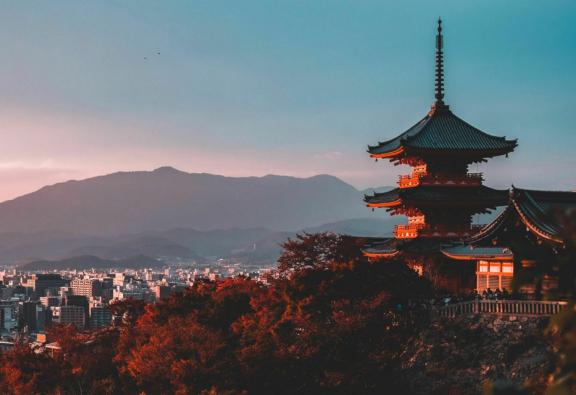 APAC Pagoda overlooking Kyoto at sunset with mountains in the distance