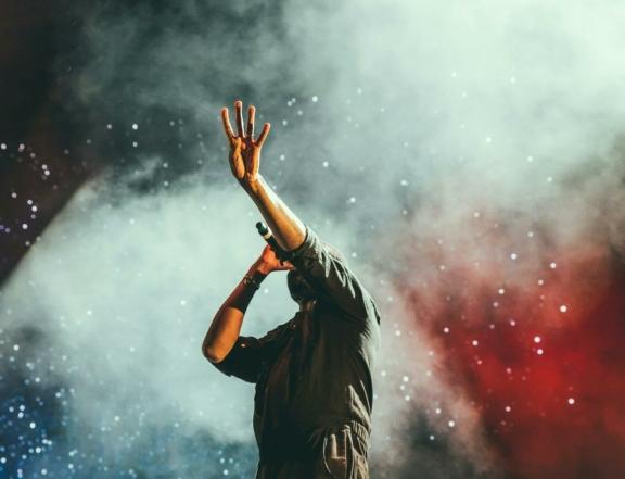 Music Entertainment 1 min Singer holding a microphone amid colorful stage smoke