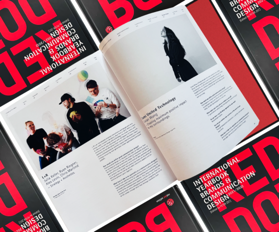 Open design magazine spread on black and red International Yearbook of Brand Communication covers