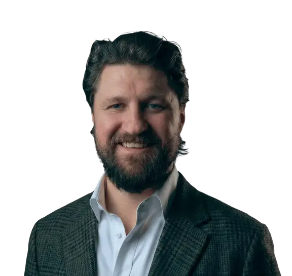 Download Smiling bearded man in a dark blazer against a black background