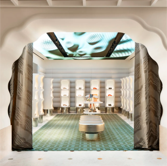 Printemps VDSM Modern boutique interior with illuminated shelves and patterned teal floor