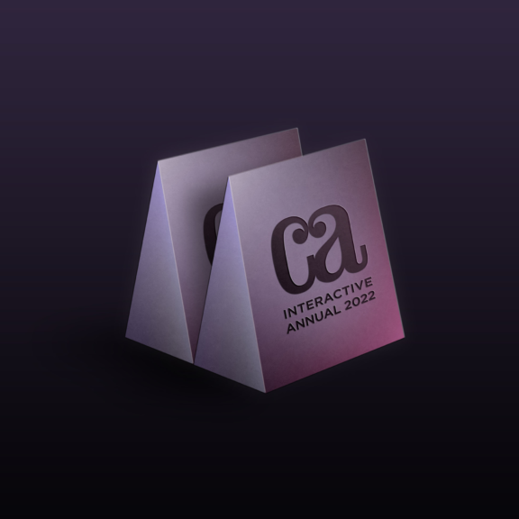 Folded card mockup reading CA Interactive Annual 2022 on dark gradient