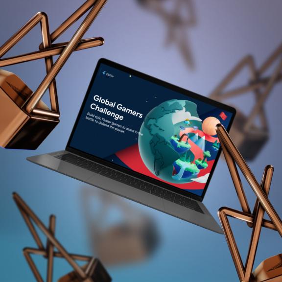 Laptop showing Global Gamers Challenge surrounded by bronze abstract shapes