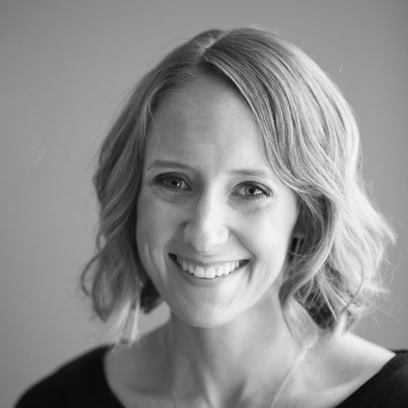 Black-and-white close-up portrait of a smiling woman