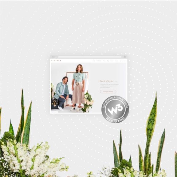 Website mockup with W3 award badge surrounded by plants