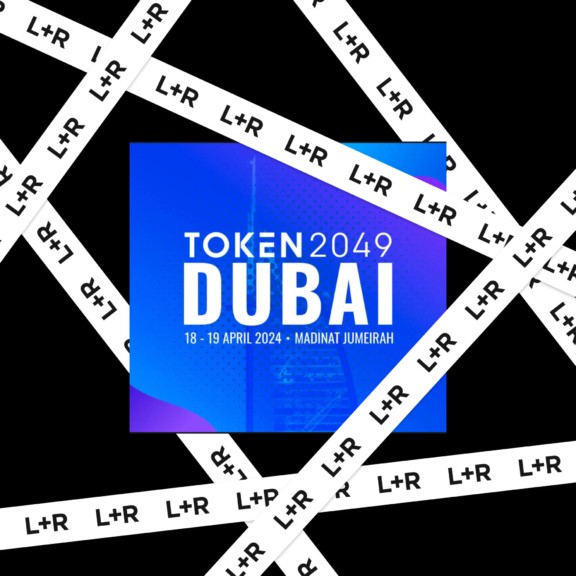 TOKEN2049 Dubai graphic framed by diagonal L+R branded tape on black