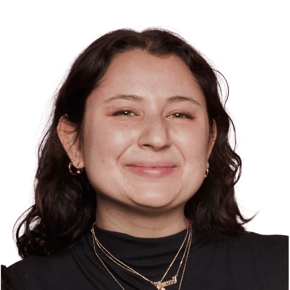 Violet Smiling woman in black top against a green background