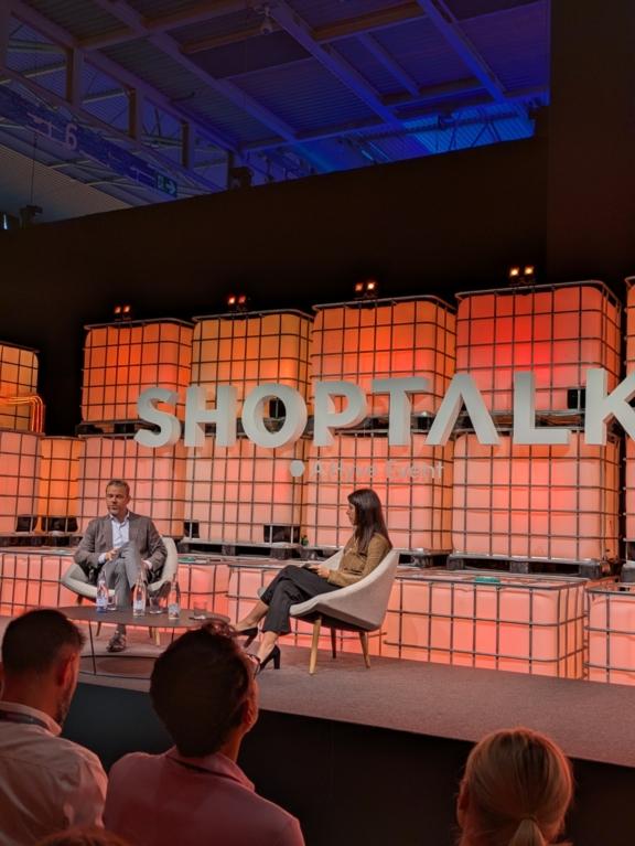 Two speakers seated on a Shoptalk stage