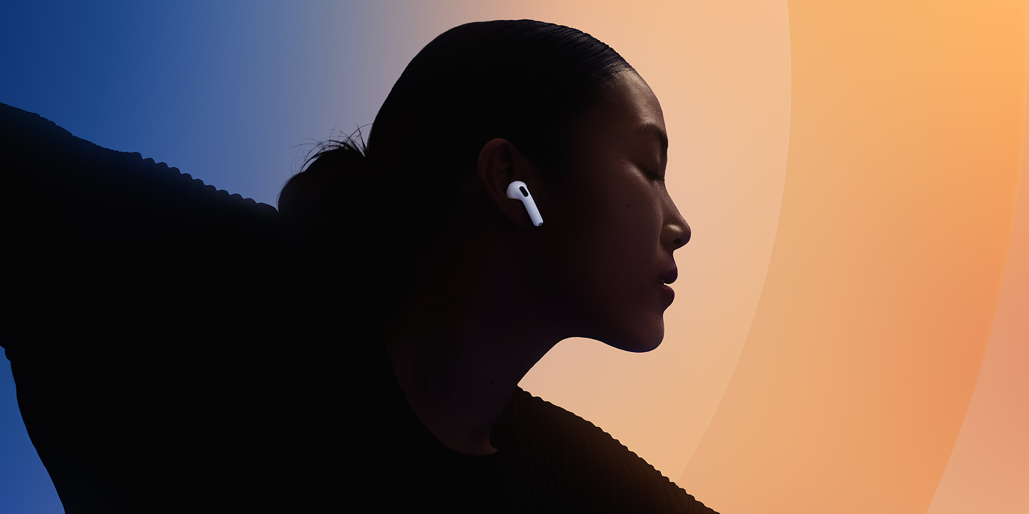 Person wearing AirPods against a blue and orange gradient background.