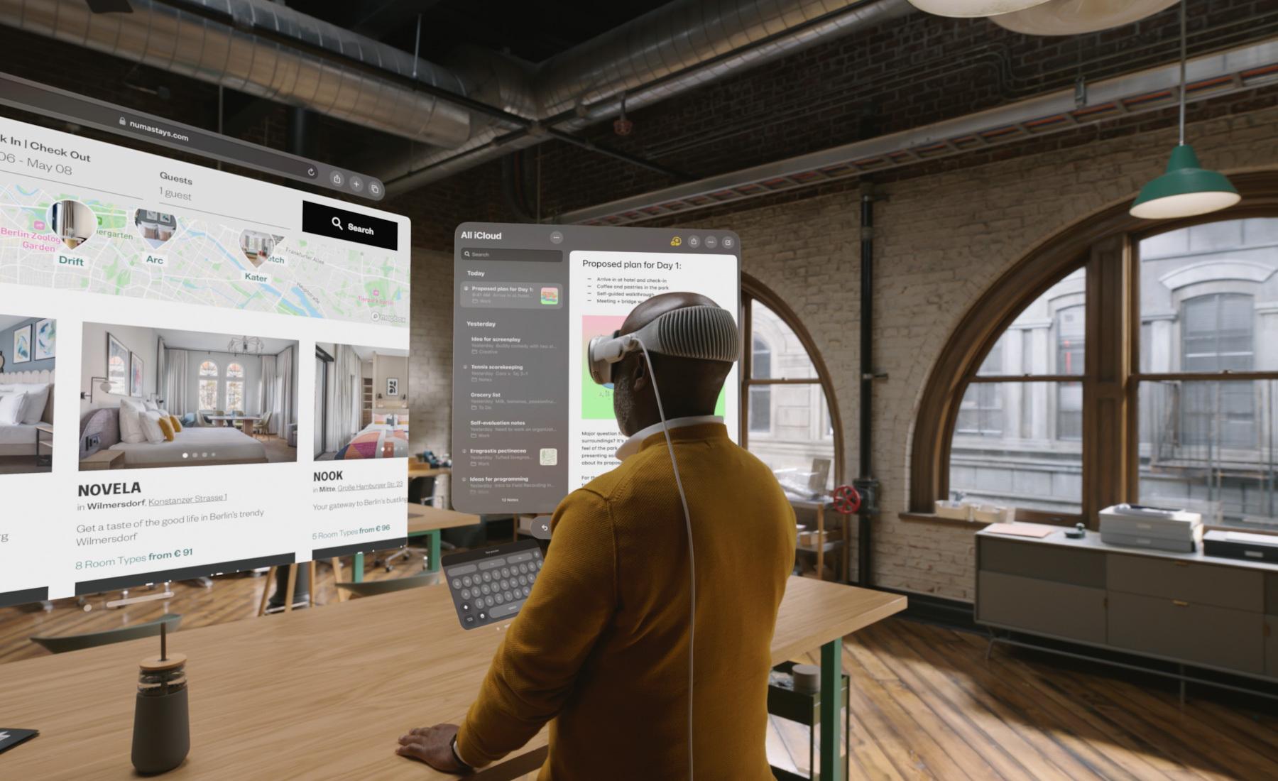 Person wearing a VR headset views floating real estate interface screens in an office.