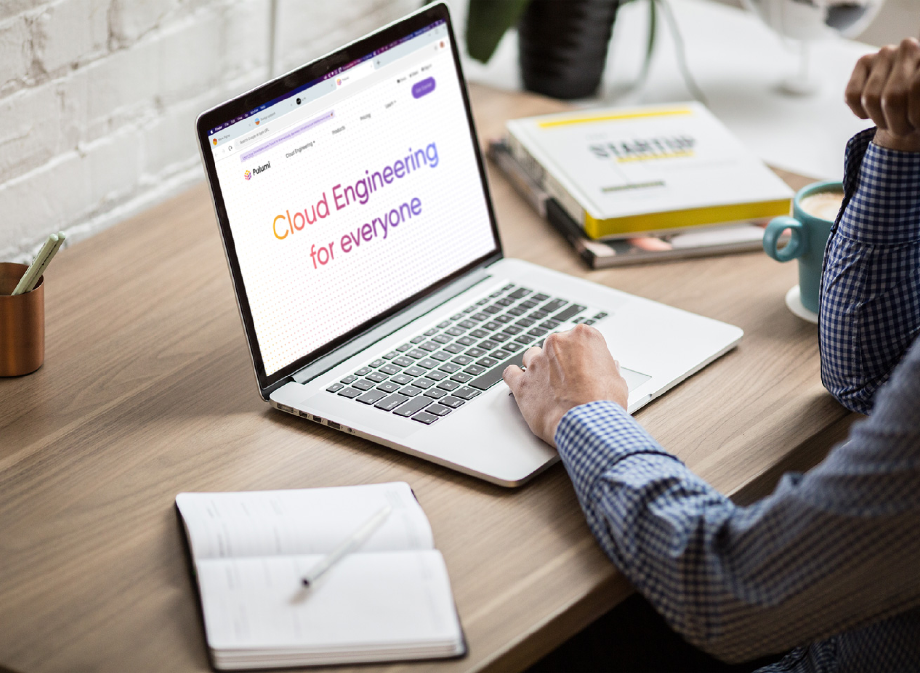 Person using a laptop displaying "Cloud Engineering for everyone"