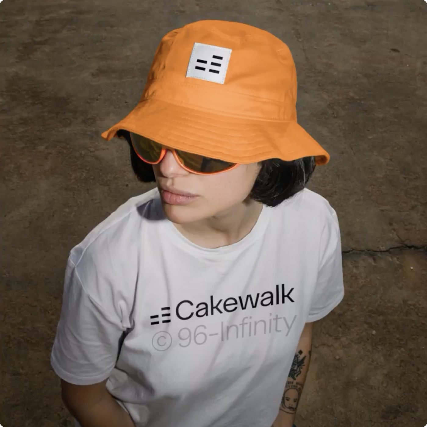 Person wearing an orange branded bucket hat and a Cakewalk T-shirt.