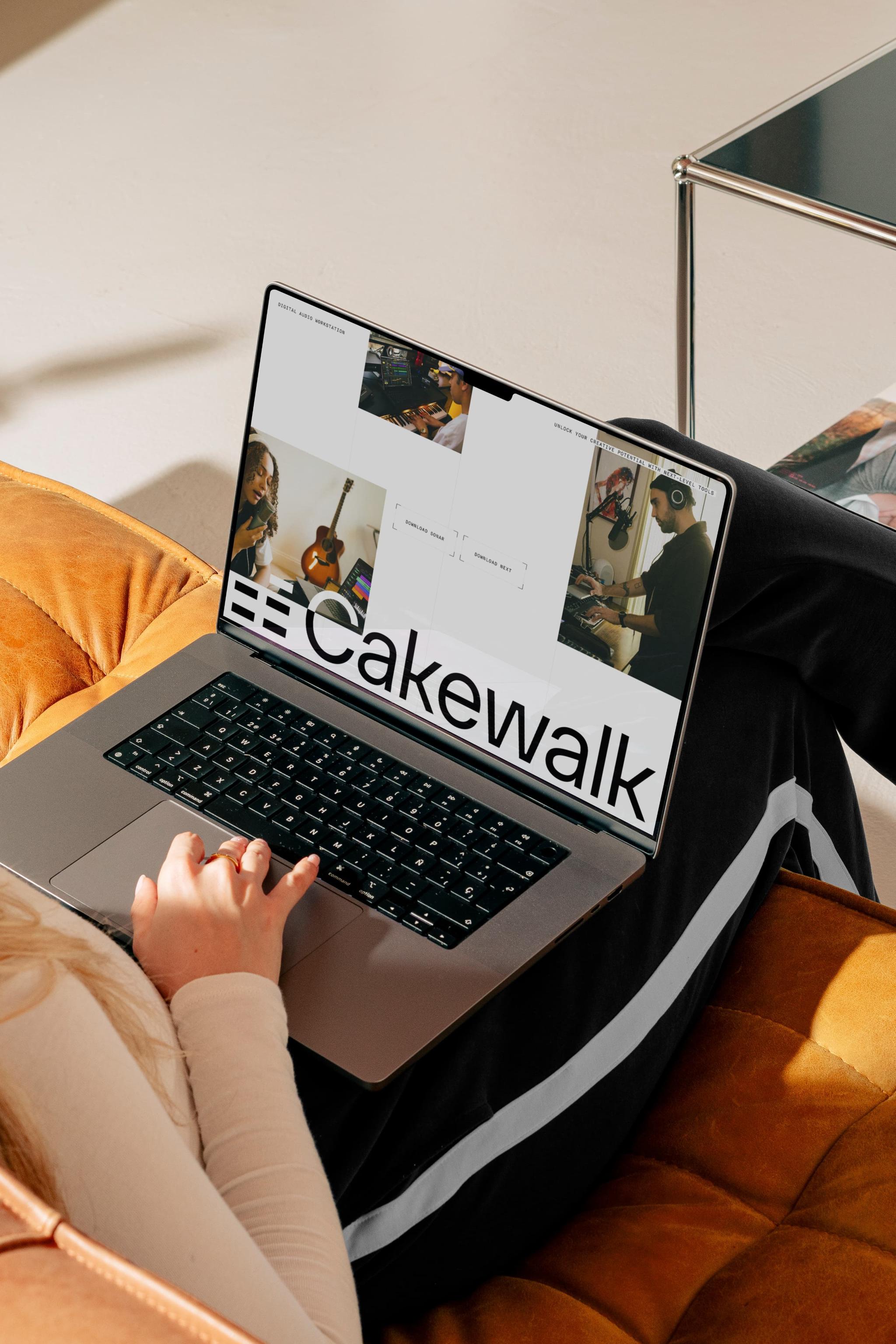 Laptop on a couch displaying Cakewalk branding and music-related visuals.