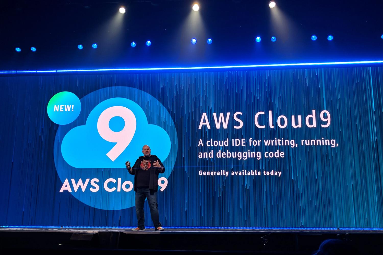 Presenter on stage introducing AWS Cloud9, a cloud IDE for writing, running, and debugging code