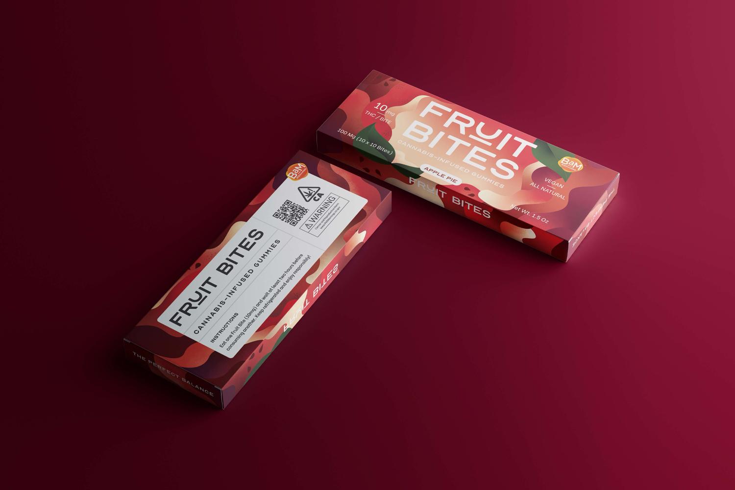 Two red Fruit Bites snack boxes on a dark red surface