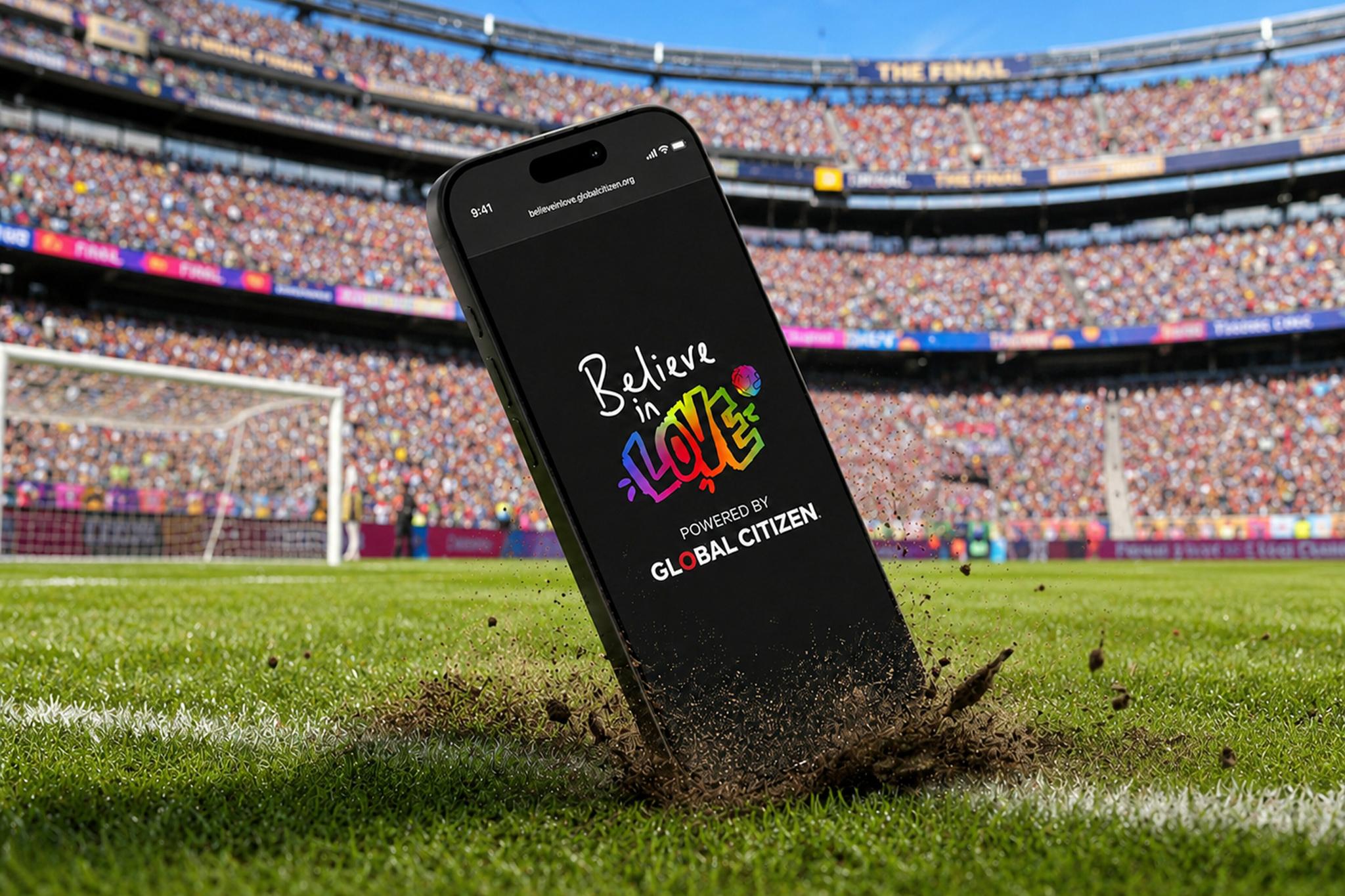 Phone standing on stadium turf with the Believe in Love app open.