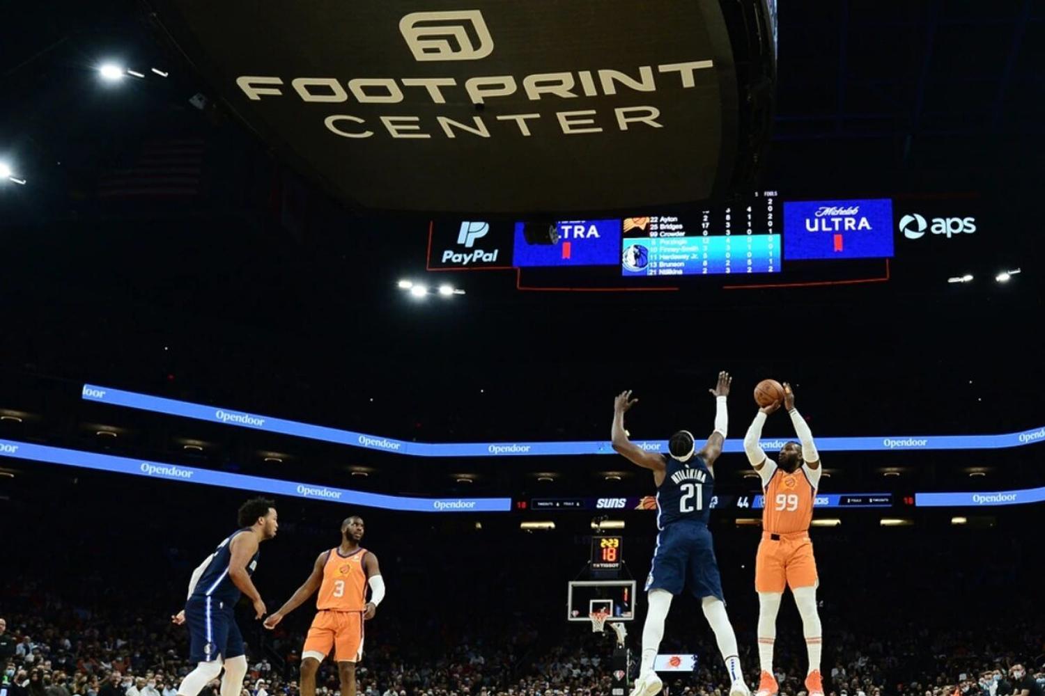 Wide view of basketball game under Footprint Center scoreboard