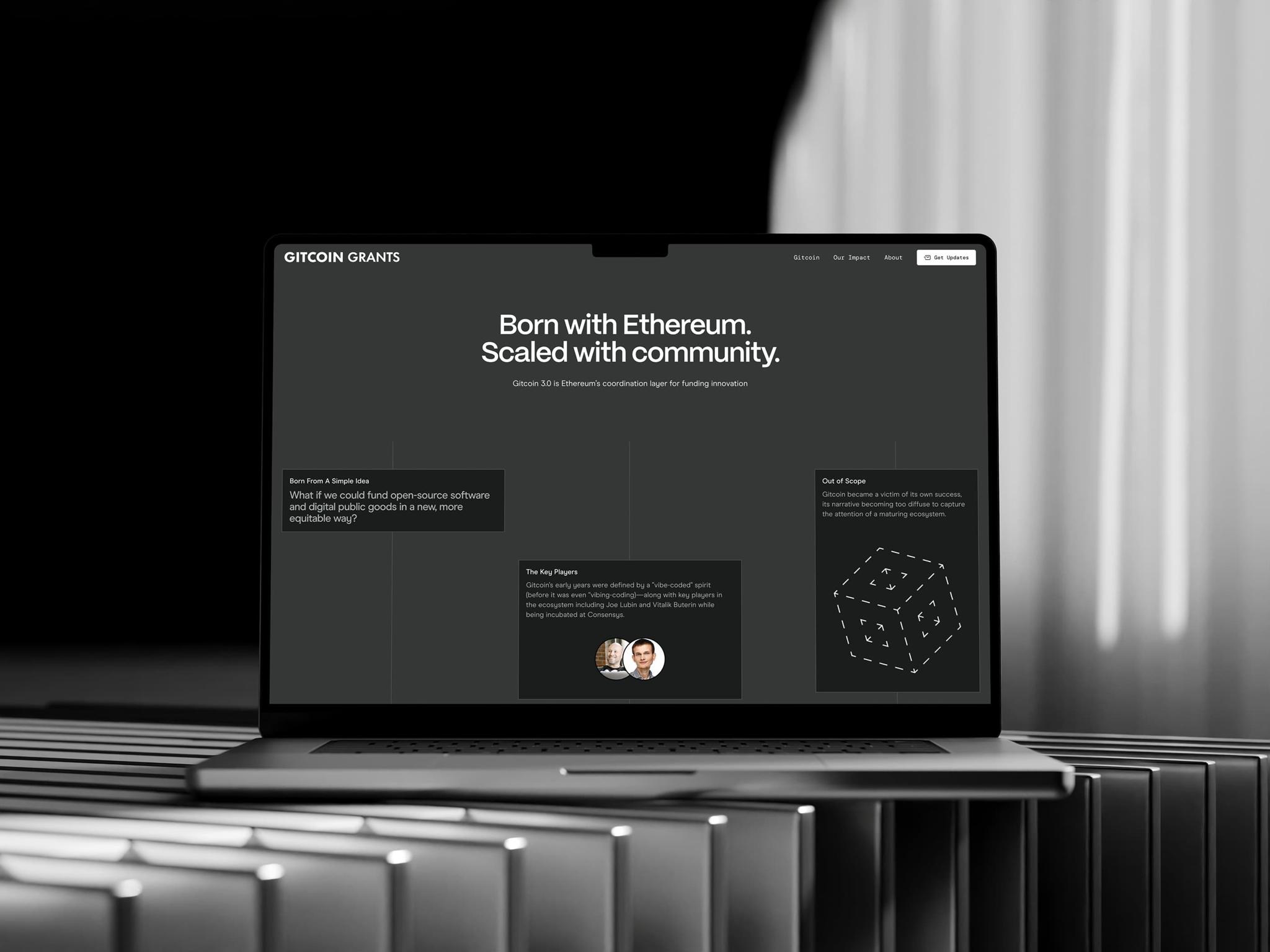 Laptop on a metallic table shows a dark Gitcoin Grants landing page.
