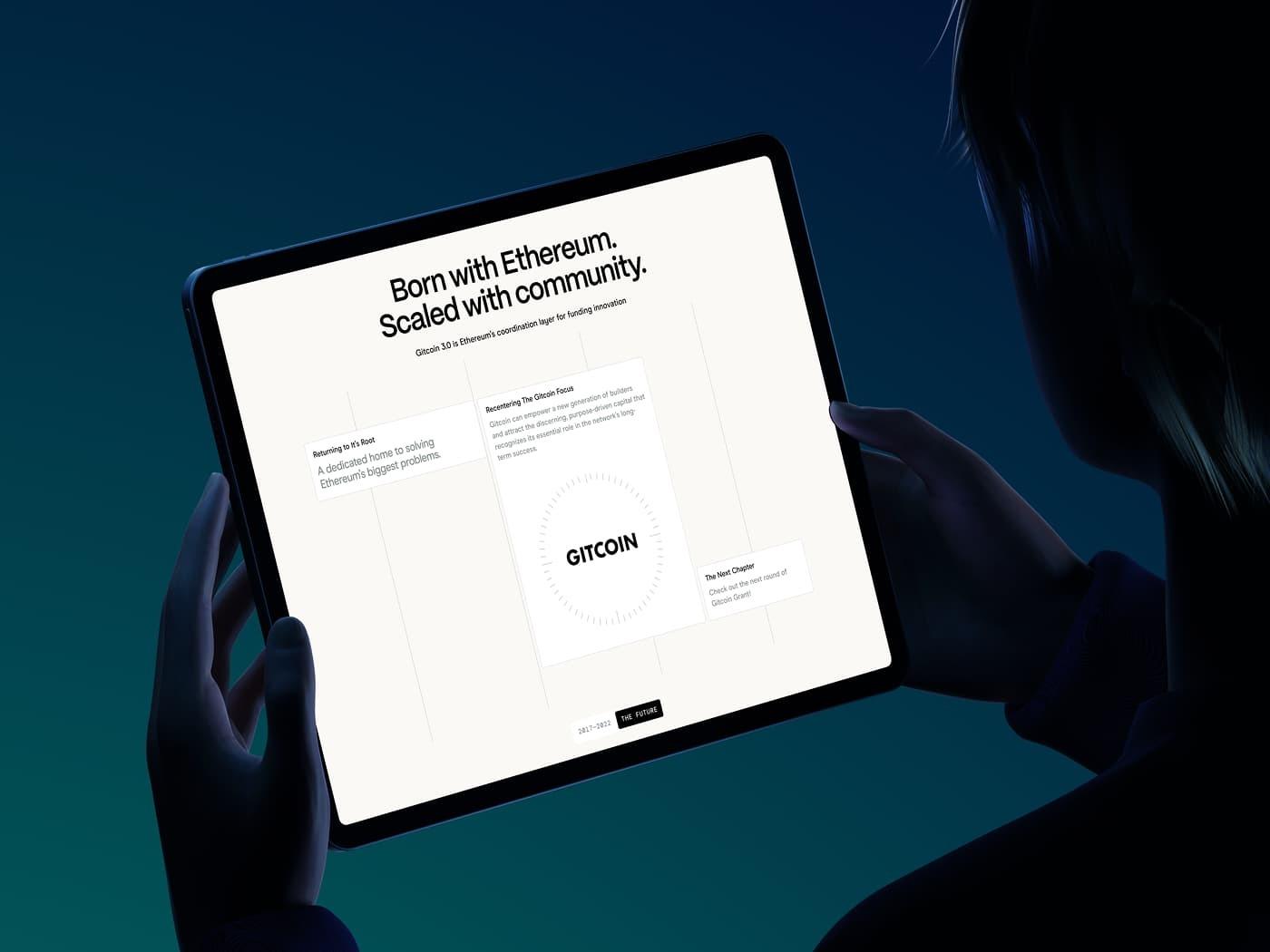 Tablet held by a person shows a Gitcoin page with cards around a central logo.
