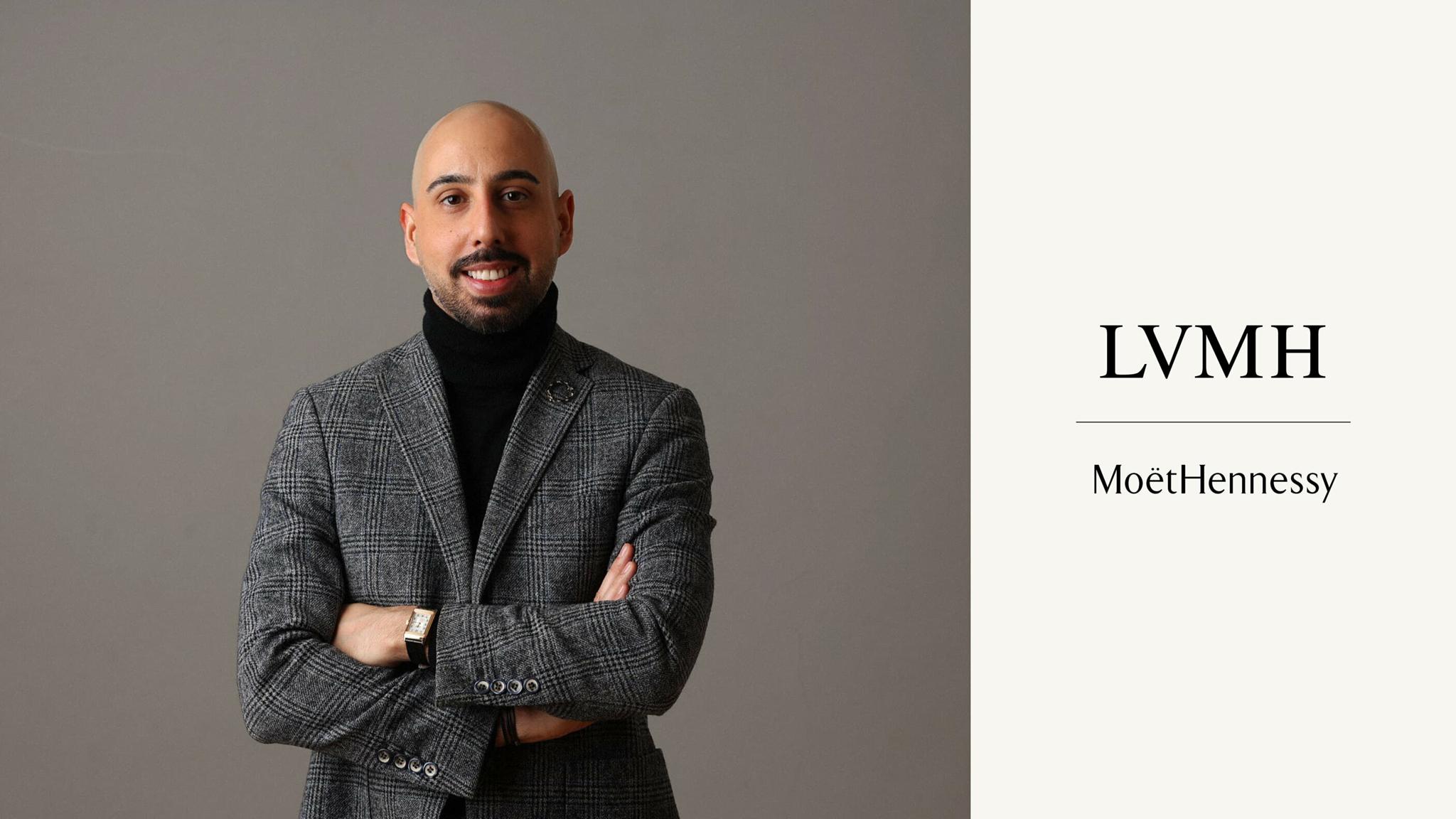 Man in a blazer beside LVMH and Moet Hennessy text.